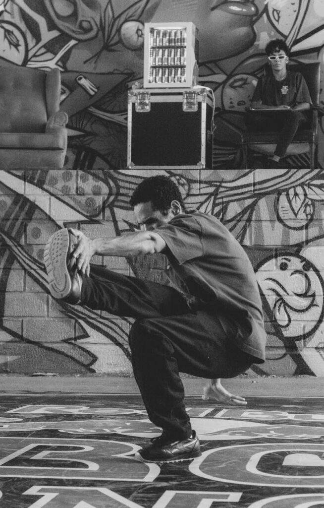 black and white photo of a man doing dance moves