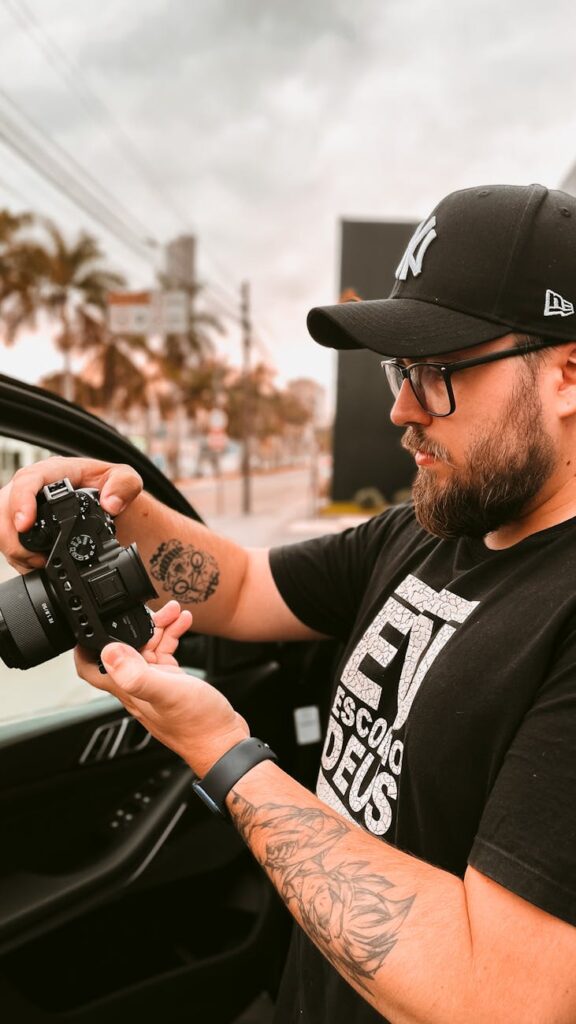 a man in black shirt holding black camera