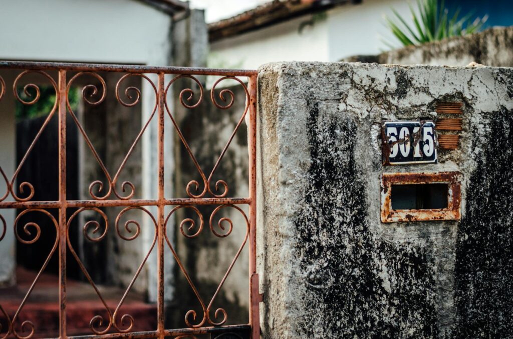 close up of an old fence and gate in front of a house