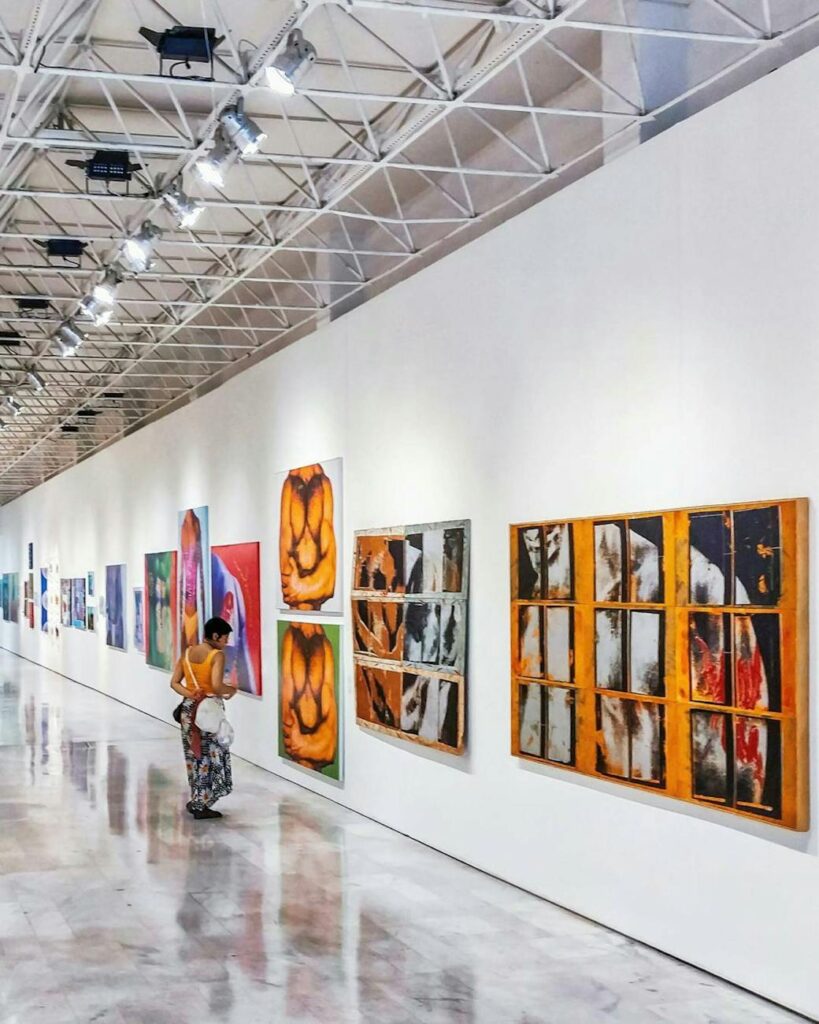 woman looking at paintings