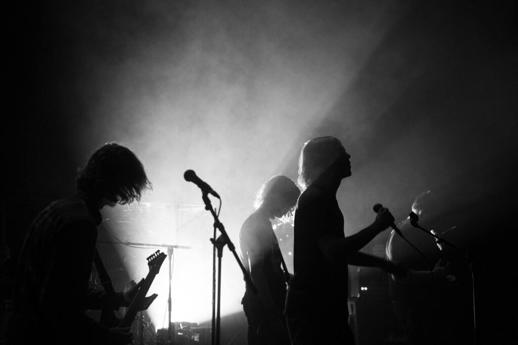 silhouette of rock band performing live on stage