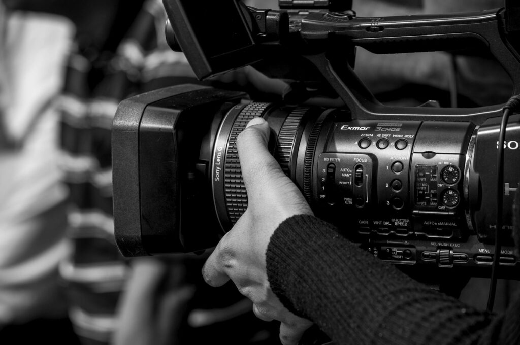 close up of hand operating professional video camera