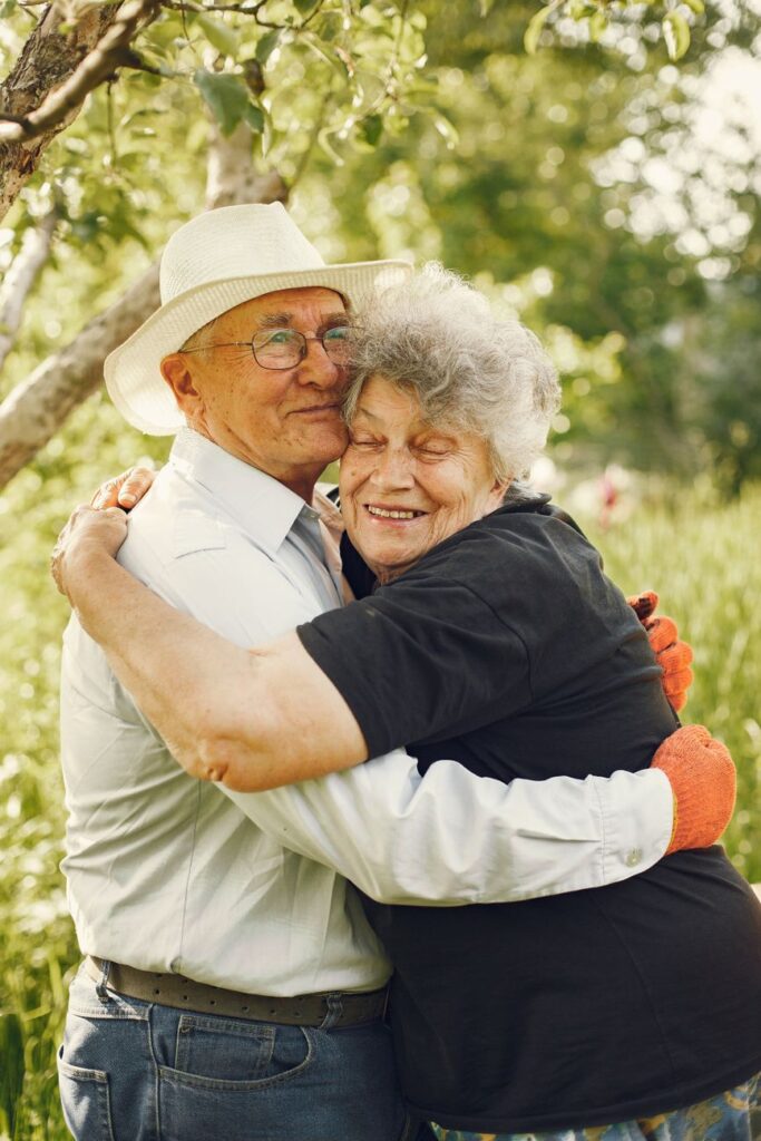an elderly couple hugging each other